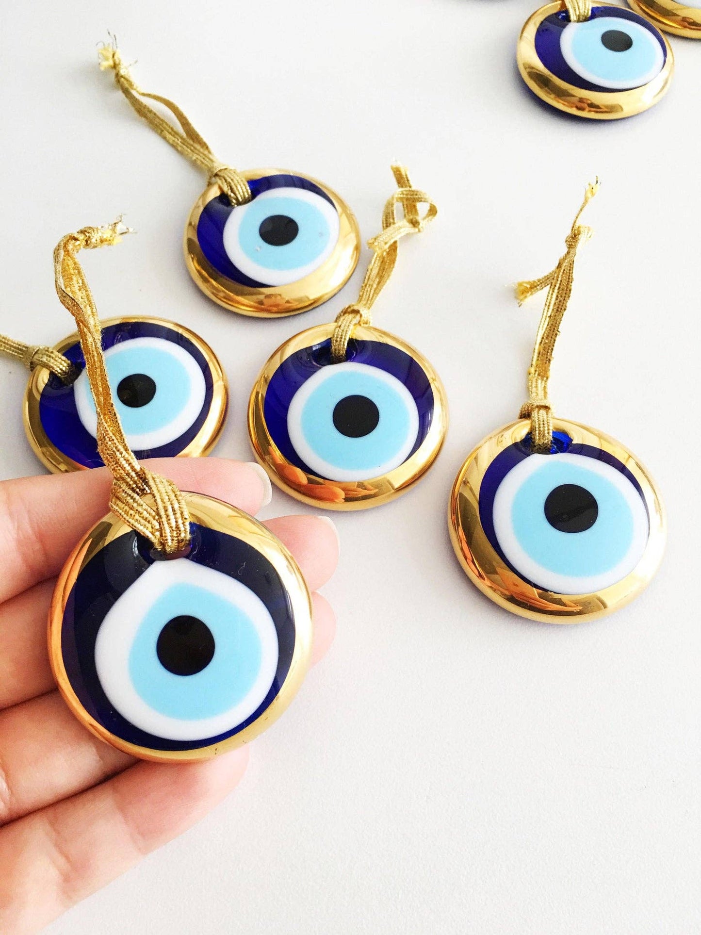 Gold trimmed glass evil eye beads with gold ropes