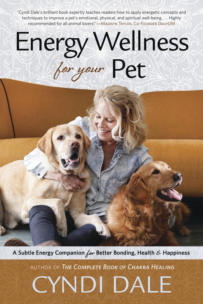 The product cover of "Energy Wellness for Your Pet" by Cyndi Dale from Llewellyn Worldwide. The image features the author smiling and sitting on a couch, gently hugging a happy golden retriever. The subtitle reads, "A Subtle Energy Companion for Better Bonding, Health & Happiness Using Vibrational Medicine.